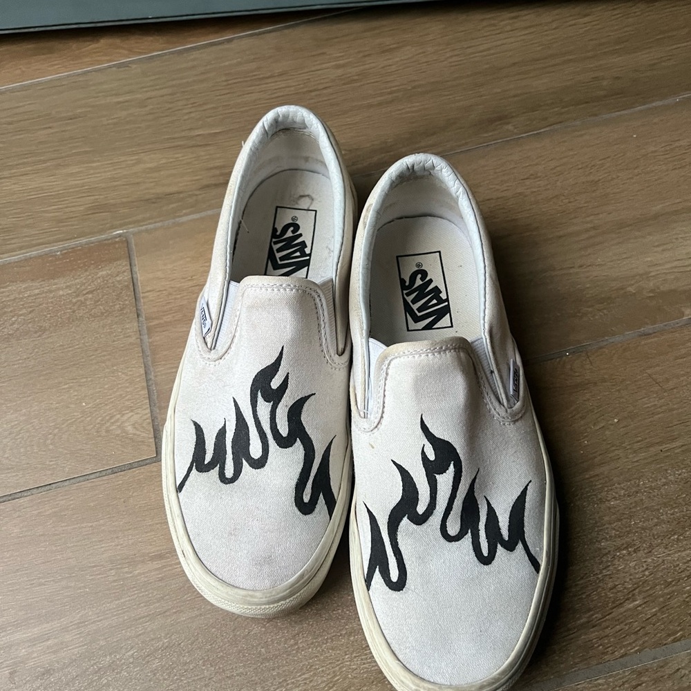 Vans White Slip-On Shoes with Black Flame Design